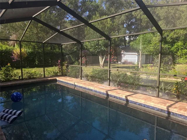 a view of a house with a yard and sitting area