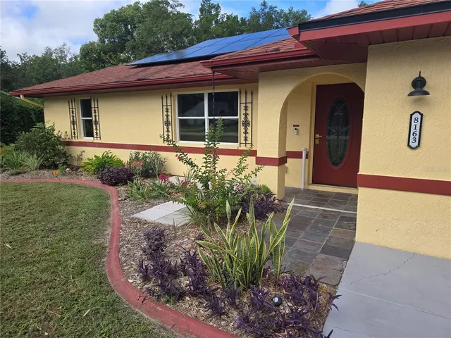 a front view of a house with garden