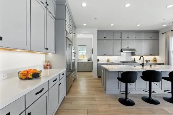 a kitchen with stainless steel appliances a sink stove and cabinets