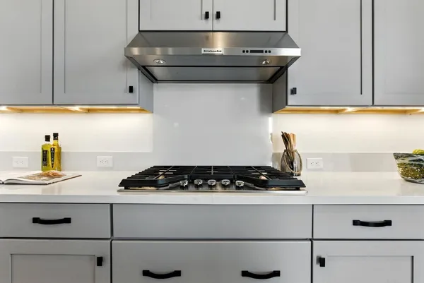 a living room with furniture a flat screen tv and kitchen view