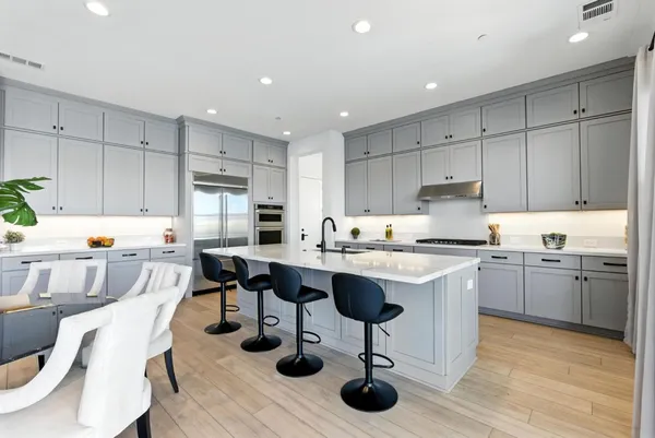 a dining room with furniture and a floor to ceiling window