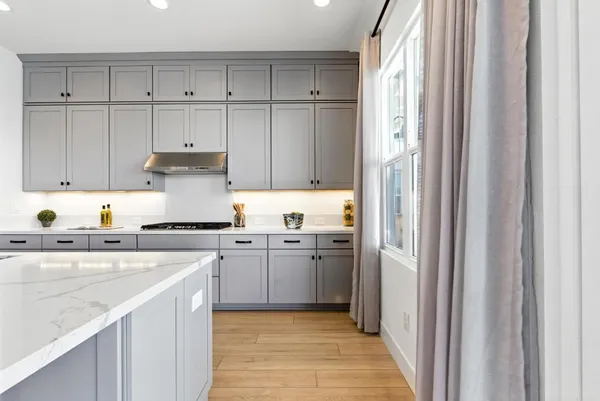 a bathroom with a granite countertop sink a toilet a shower and a mirror