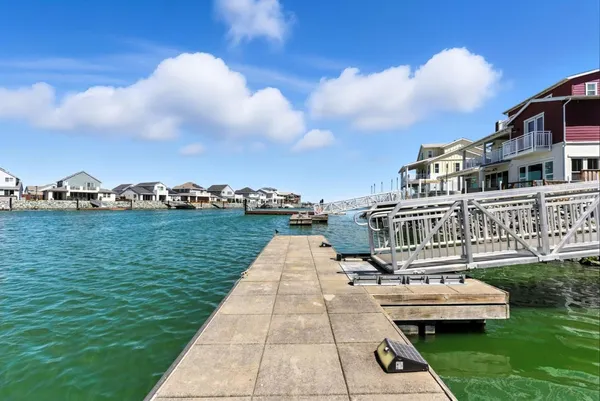 a front view of a house with a yard and potted plants