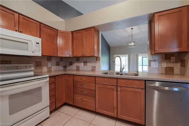 a kitchen with cabinets a sink and appliances