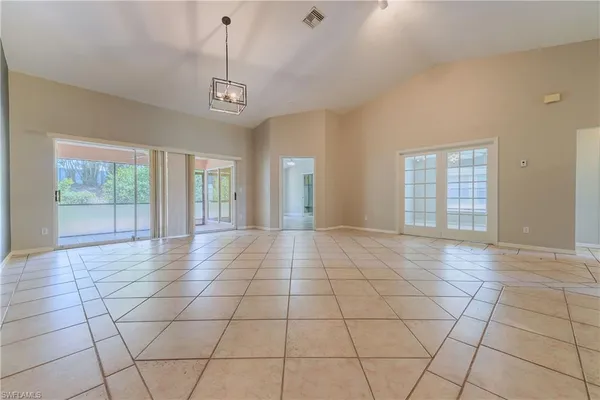 a view of an empty room with glass door