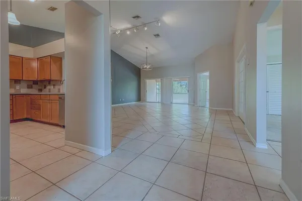 a view of hallway with a window and kitchen view