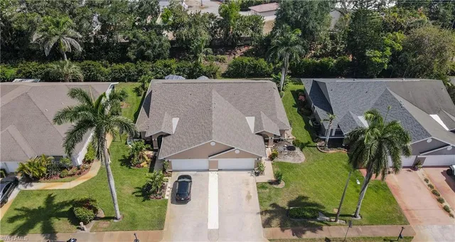an aerial view of a house with garden space and lake view