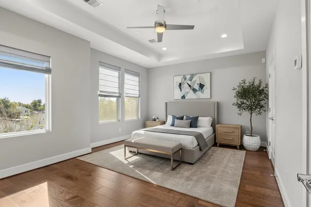 a bedroom with a large bed and a chandelier