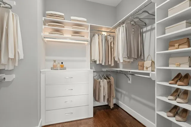 a view of walk in closet with clothes and shoes