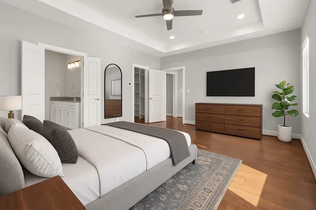 a bedroom with a large bed and a flat screen tv