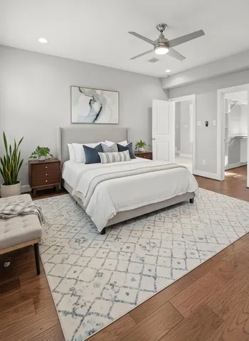 a bedroom with a large bed and a chandelier