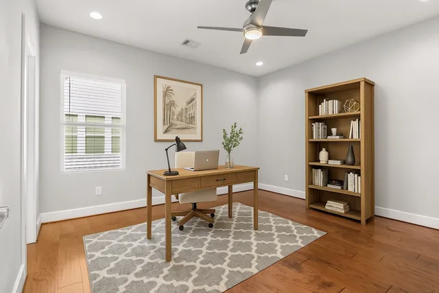 a dining room with wooden floor and a window
