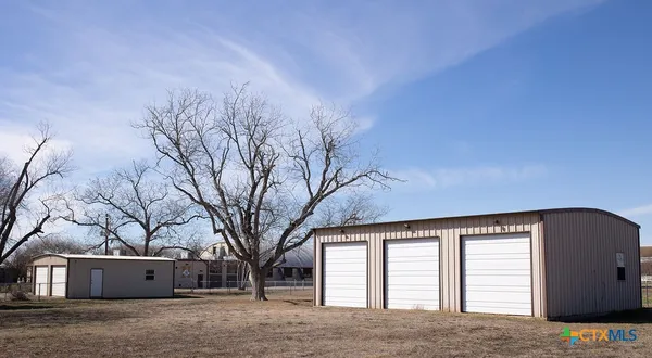 a view of house with a snow in the yard