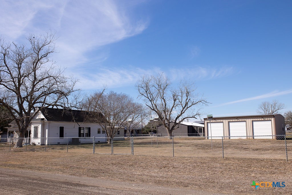 202 East 4th Street Nordheim, TX 78141 - Photo 18 of 18 a tree in front of a house with a yard