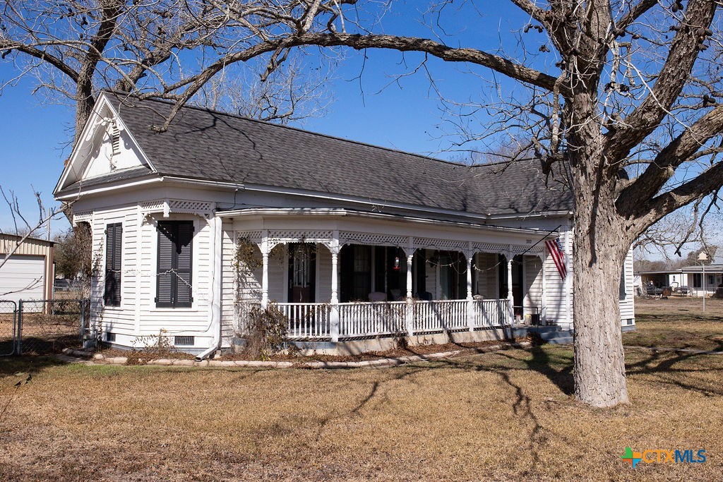202 East 4th Street Nordheim, TX 78141 - Photo 2 of 18 a view of a house with potted plants and a large tree