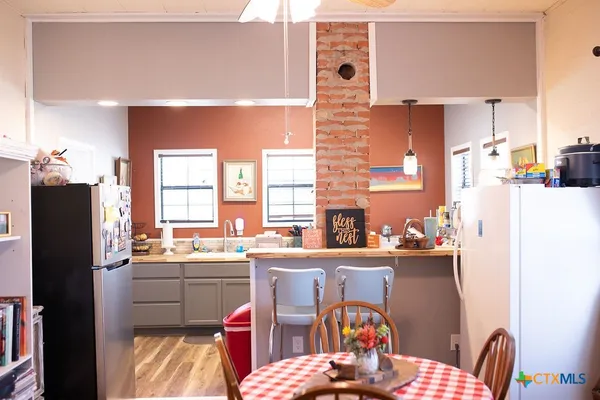 a kitchen with a sink a stove a refrigerator and furniture