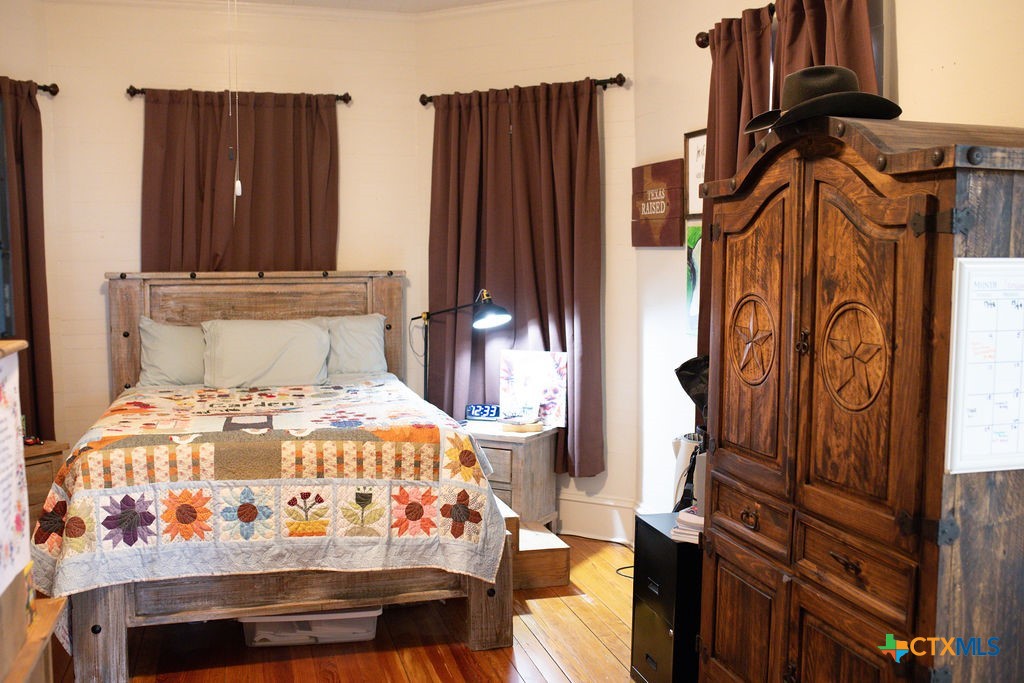 202 East 4th Street Nordheim, TX 78141 - Photo 7 of 18 a bedroom with furniture and a mirror