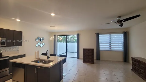 a kitchen with a sink and a refrigerator