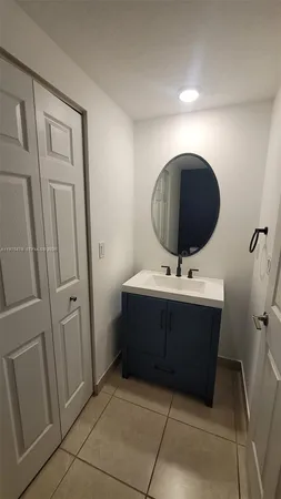 a bathroom with a sink and mirror