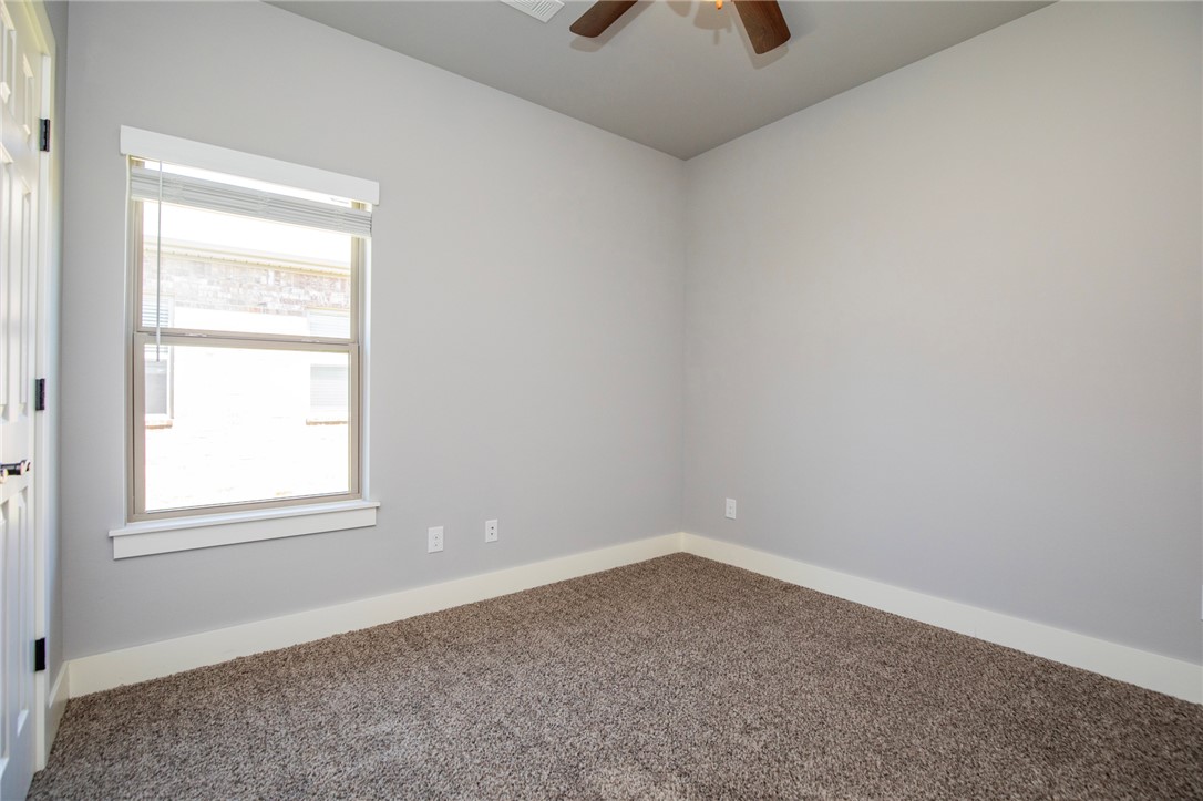 214 Alder Street Pea Ridge, AR 72751 - Photo 13 of 20 Carpeted room featuring a single window with blinds, light gray wall paint, white baseboards, and a ceiling fan