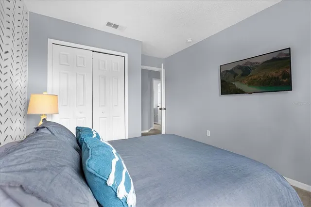 a bedroom with bed and a chandelier