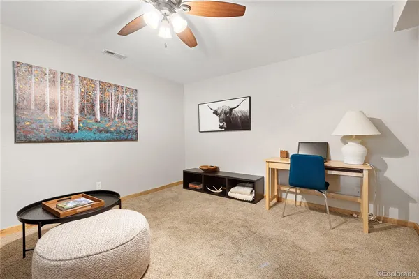 a living room with furniture and a chair