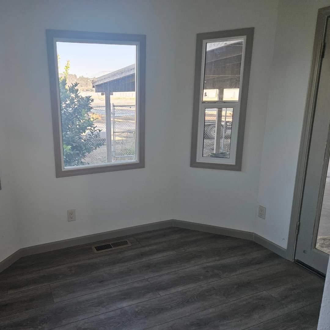 120 Trafton Road Watsonville, CA 95076 - Photo 27 of 43 an empty room with wooden floor and windows