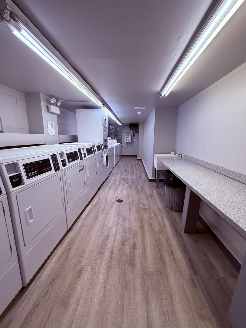 3033 North Sheridan Road, Unit 809 Chicago, IL 60657 - Photo 17 of 20 a view of a kitchen with wooden floor and electronic appliances