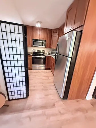 a kitchen with stainless steel appliances a refrigerator and a stove top oven