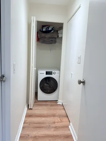 a view of a hallway with washer and dryer