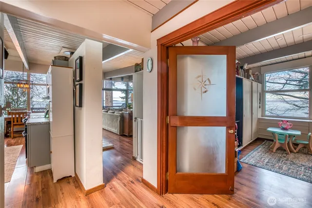 a view of a hallway and a livingroom with furniture