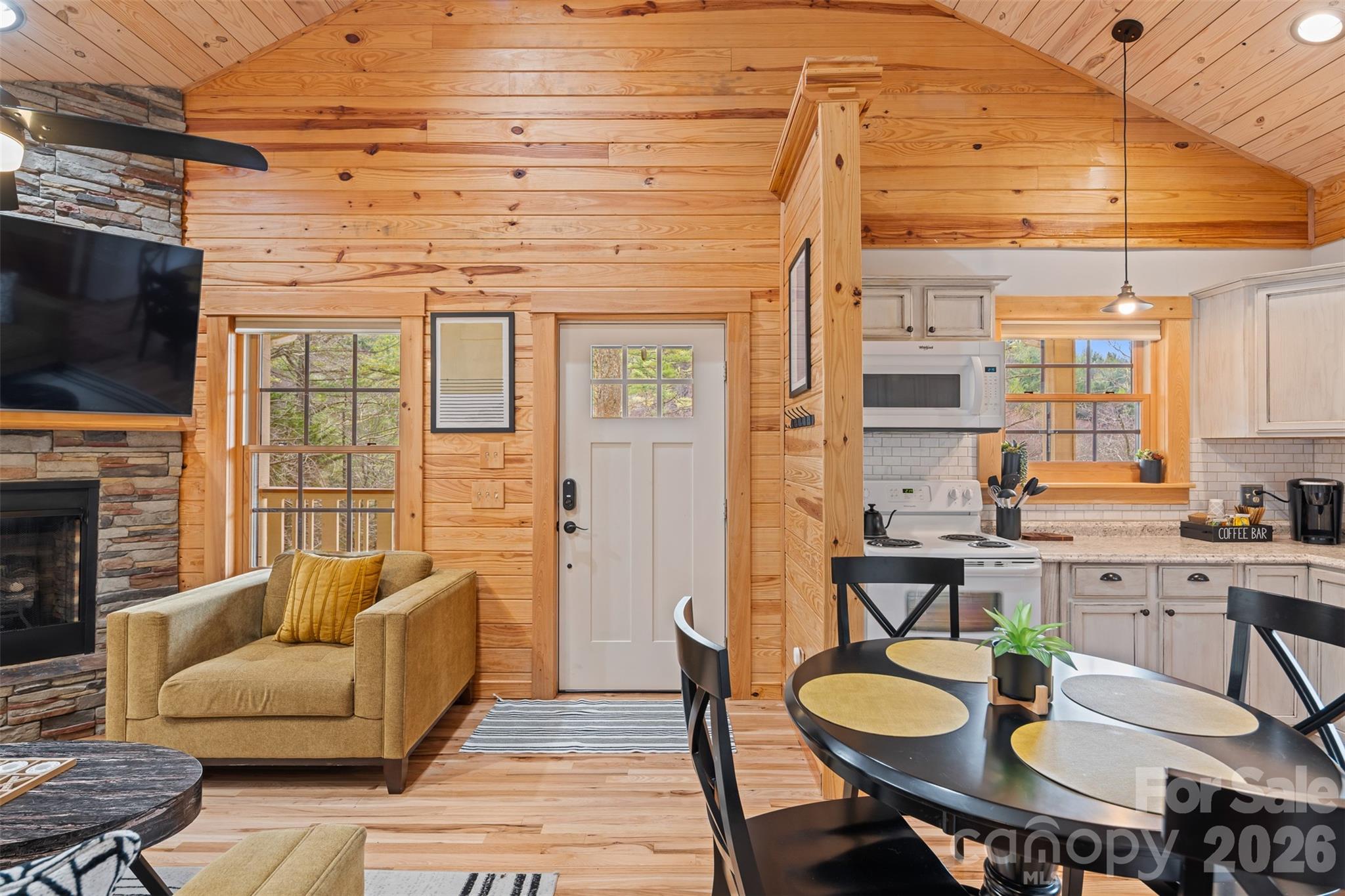 1333 Park Vista Road West Jefferson, NC 28694 - Photo 11 of 39 a living room with furniture a fireplace a flat screen tv and windows