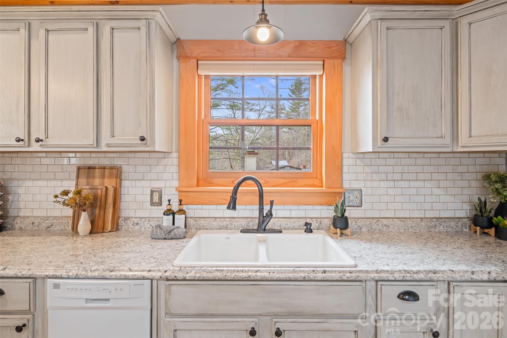 1333 Park Vista Road West Jefferson, NC 28694 - Photo 13 of 39 a kitchen with granite countertop a sink a window and cabinets