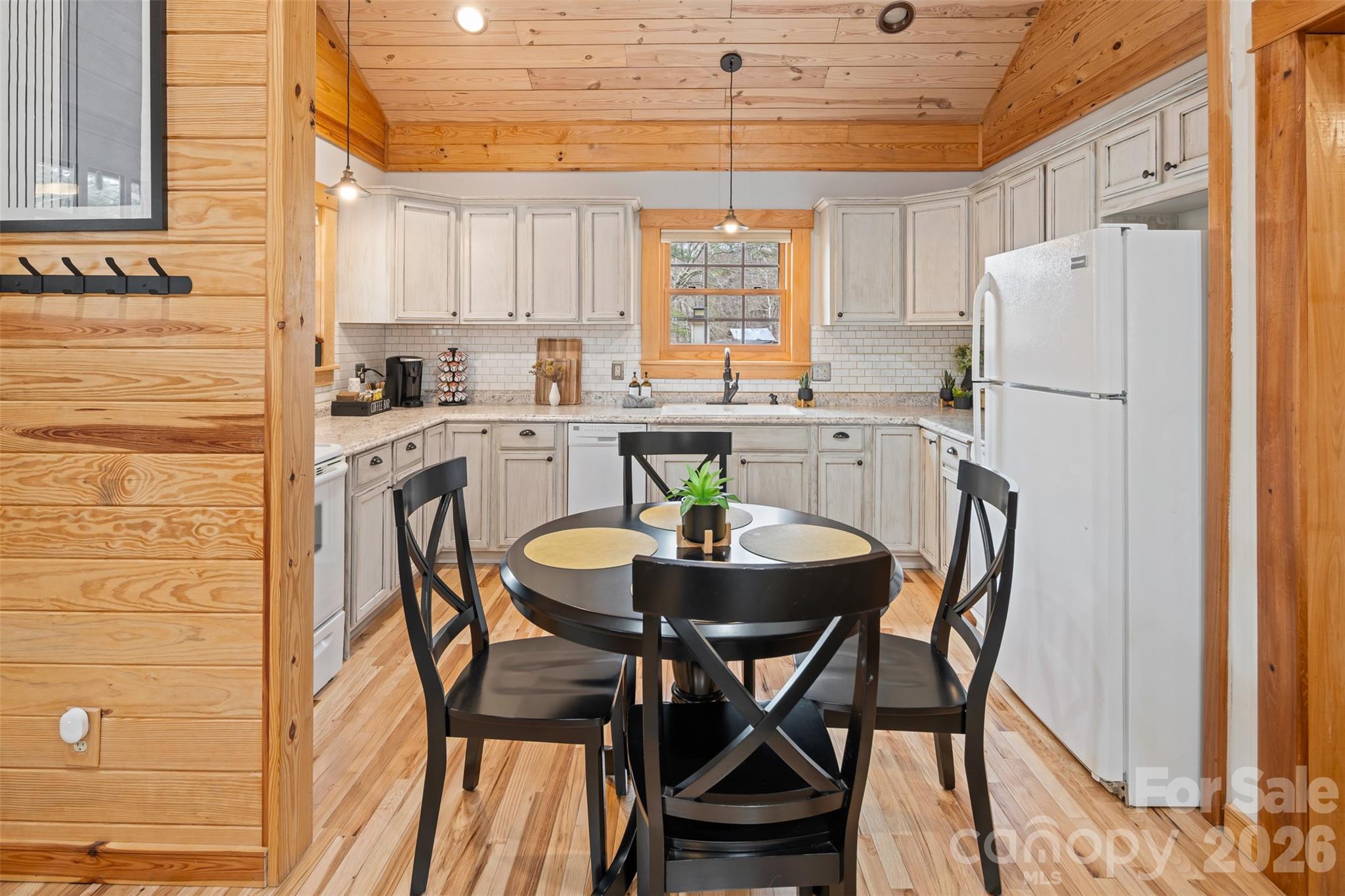 1333 Park Vista Road West Jefferson, NC 28694 - Photo 7 of 39 a kitchen with stainless steel appliances a dining table chairs and a refrigerator