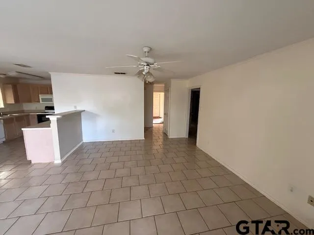a view of a kitchen with a sink and dishwasher a stove top oven with wooden floor