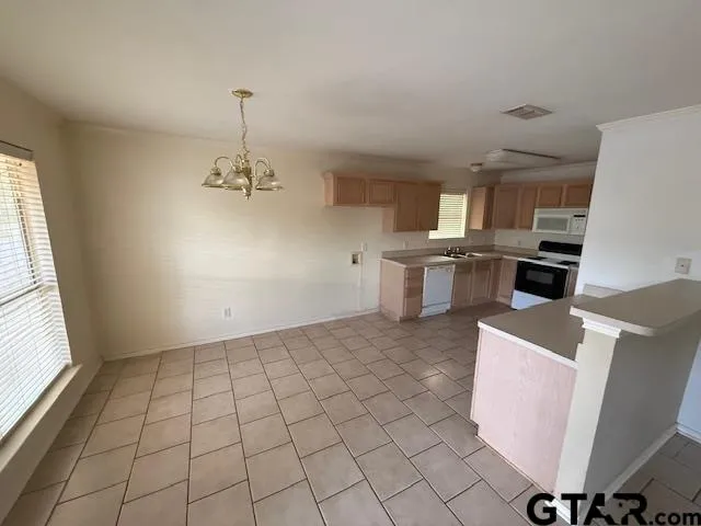 a kitchen with a sink cabinets and window