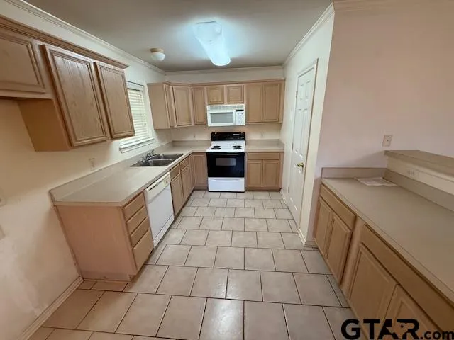 a kitchen with a stove a sink and a refrigerator