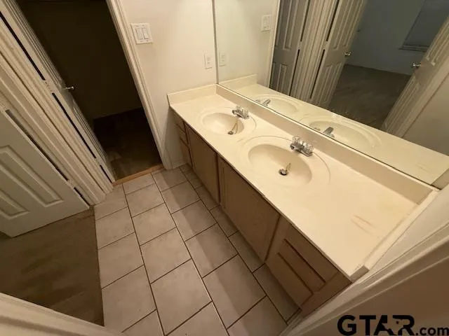 a bathroom with a sink a mirror and vanity