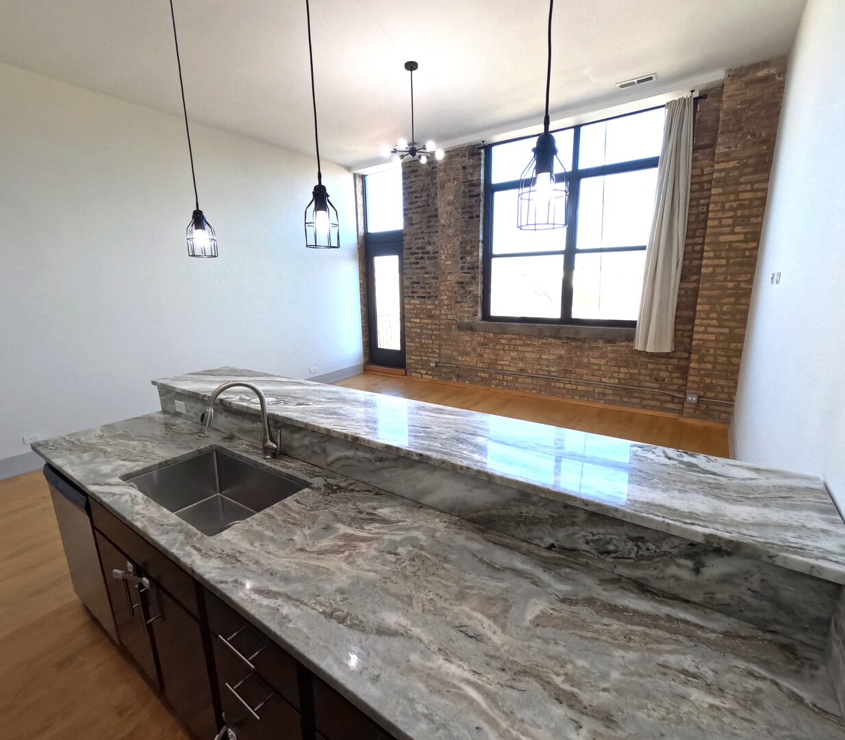 1432 West 21st Street, Unit 321 Chicago, IL 60608 - Photo 12 of 25 a kitchen with a sink a counter space and a window