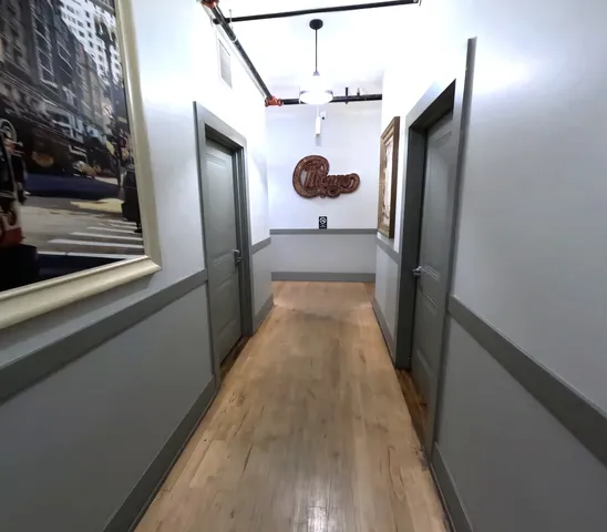 a view of a hallway and wooden floor