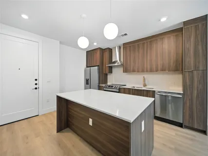 a kitchen with a sink cabinets and wooden floor