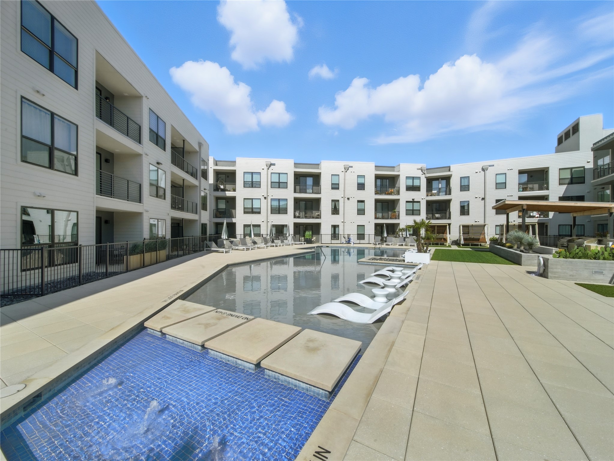 1701 Simond Avenue, Unit 302 Austin, TX 78723 - Photo 17 of 28 a view of a swimming pool with a lounge chair