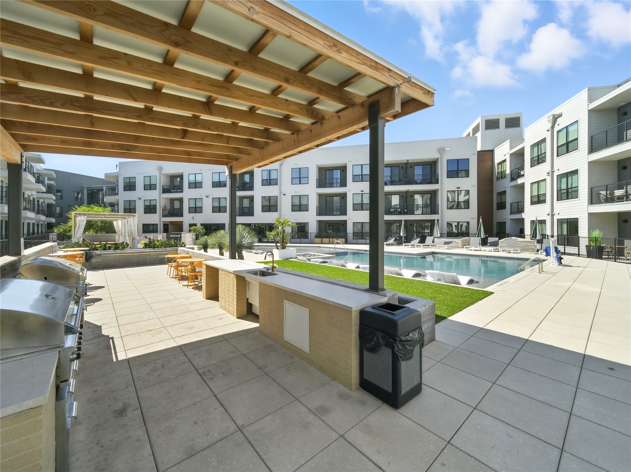 1701 Simond Avenue, Unit 302 Austin, TX 78723 - Photo 19 of 28 a swimming pool with outdoor seating