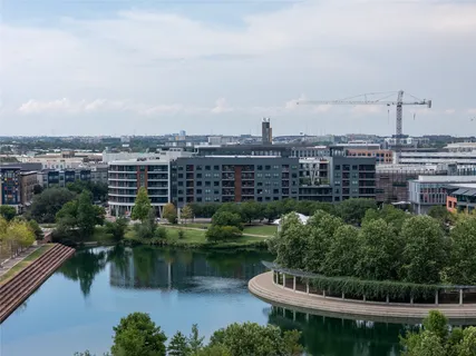 a view of a lake with a city skyline in the background