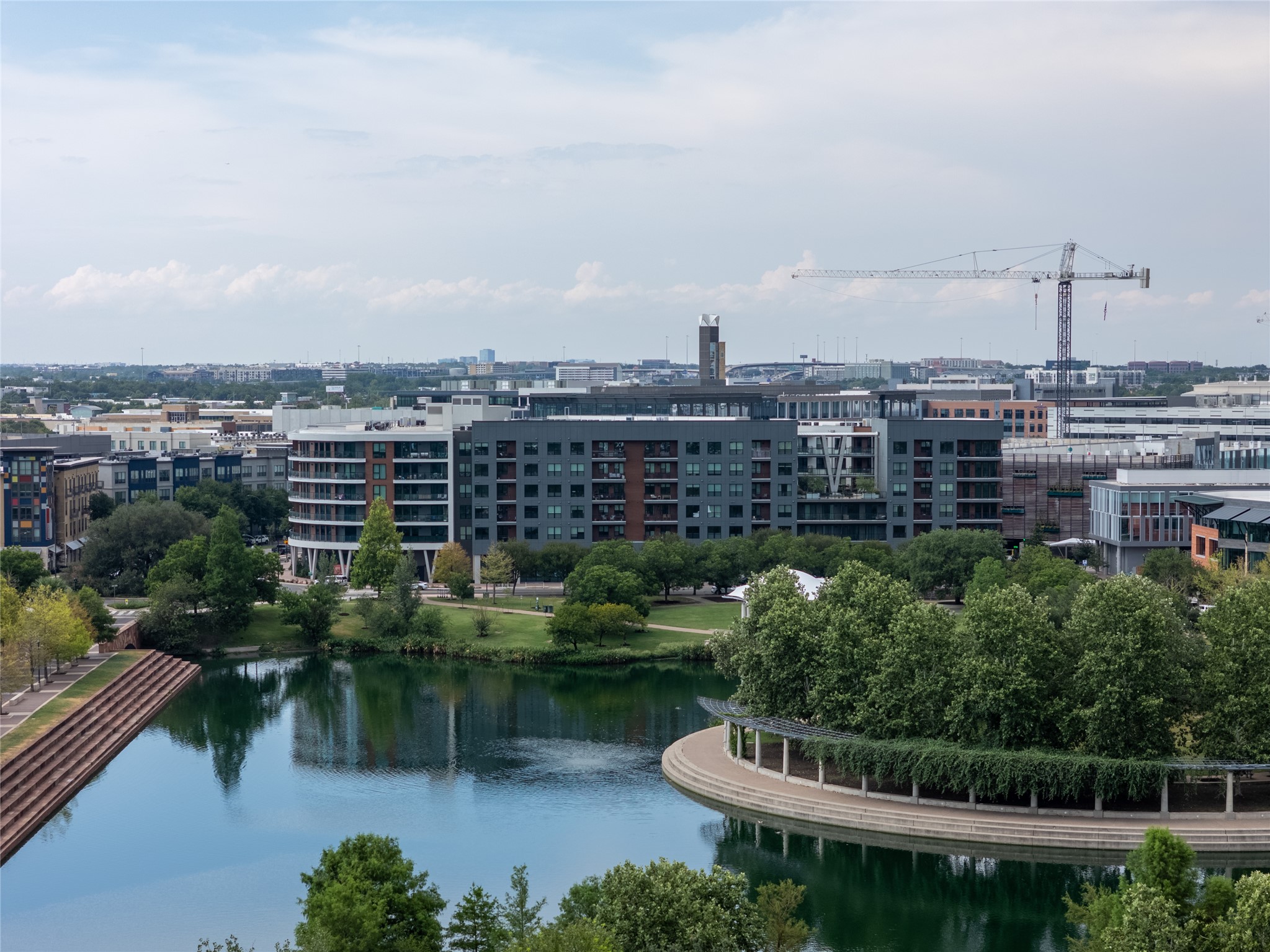 1701 Simond Avenue, Unit 302 Austin, TX 78723 - Photo 2 of 28 a view of a lake with a city skyline in the background