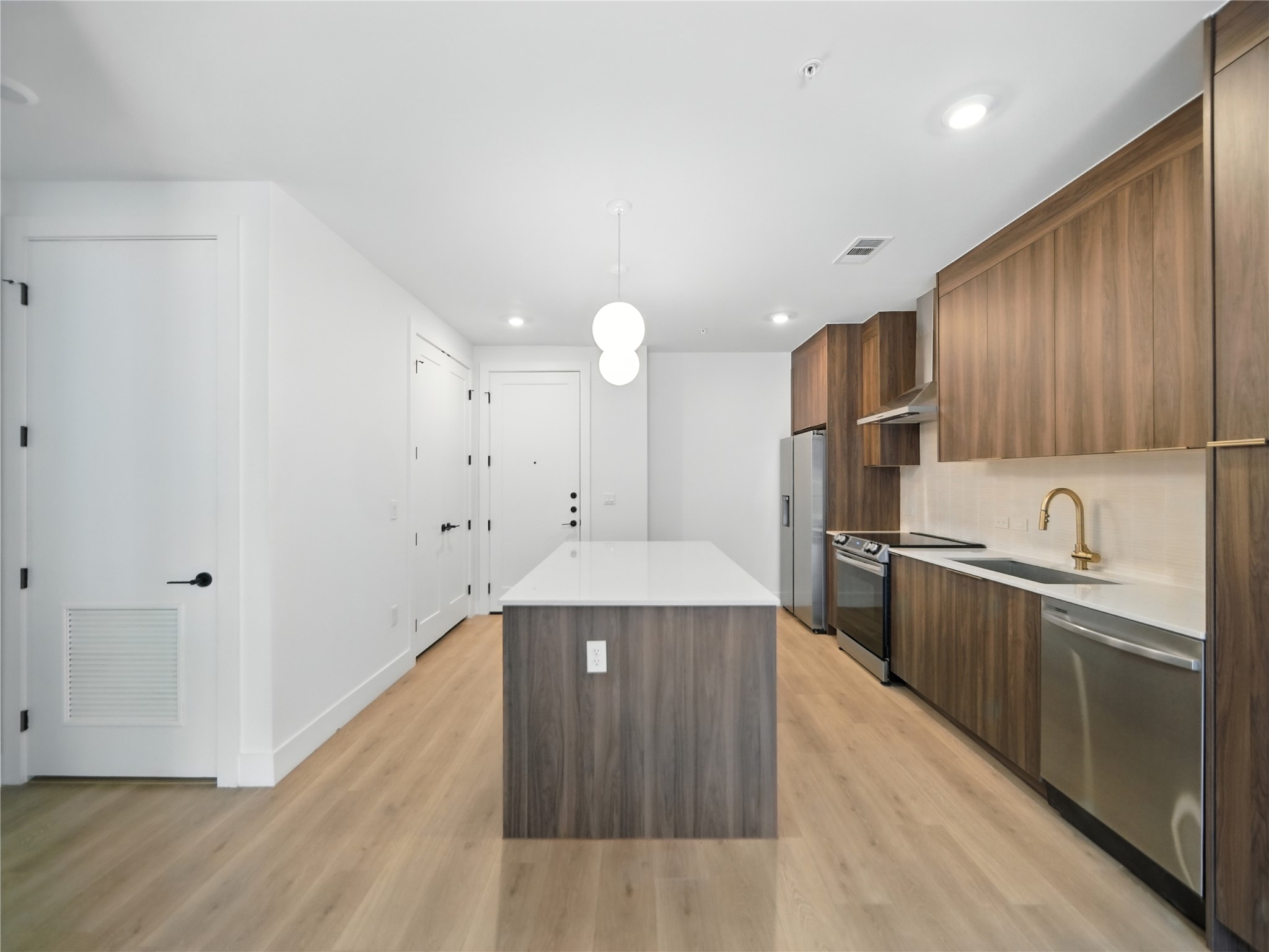 1701 Simond Avenue, Unit 302 Austin, TX 78723 - Photo 5 of 28 a large kitchen with a lot of counter space and wooden floor