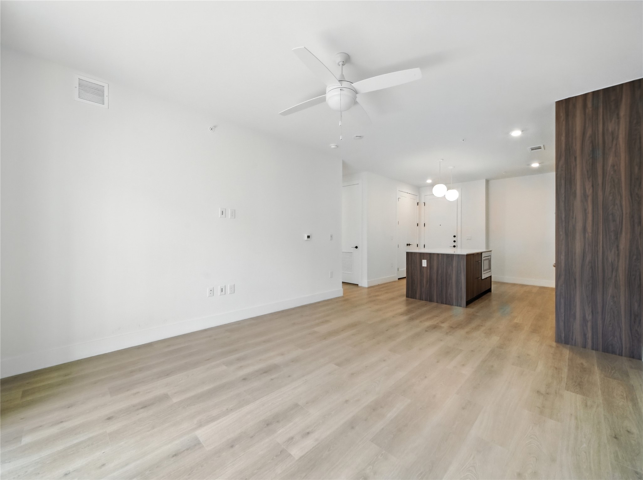 1701 Simond Avenue, Unit 302 Austin, TX 78723 - Photo 9 of 28 an empty room with wooden floor and windows