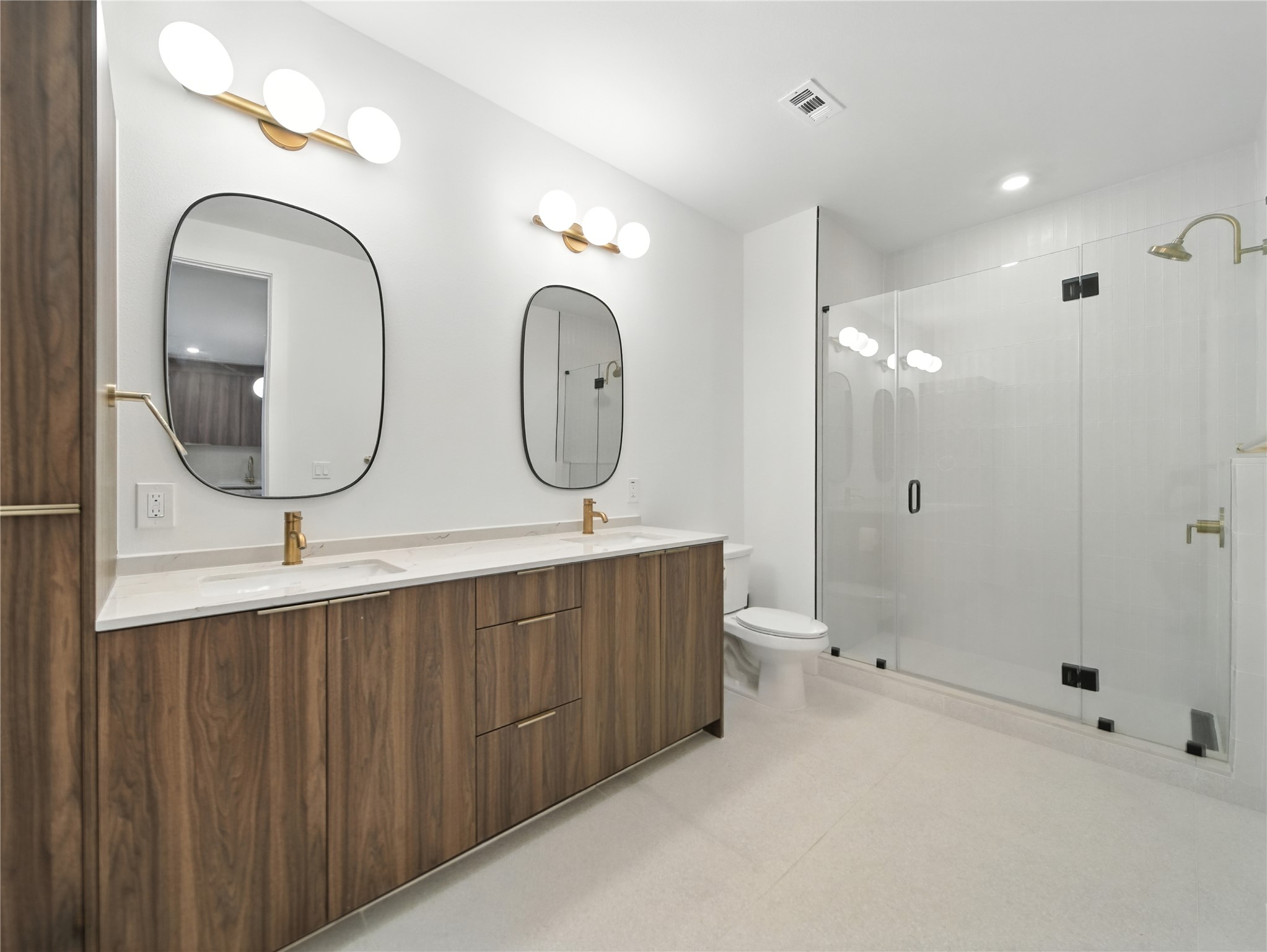 1701 Simond Avenue, Unit 302 Austin, TX 78723 - Photo 10 of 28 a bathroom with a double vanity sink and a mirror