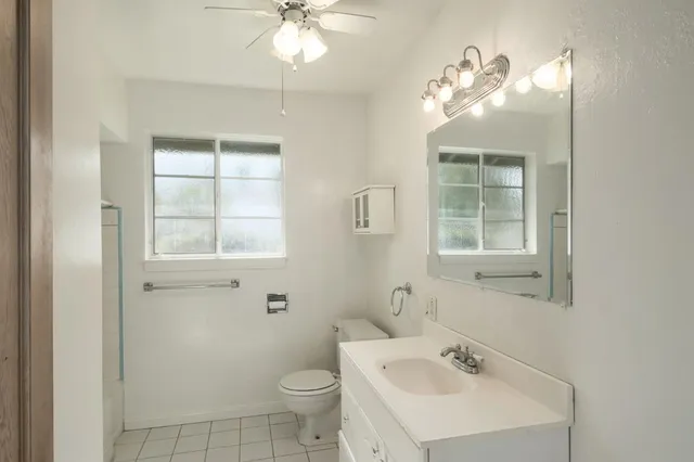 a bathroom with a sink toilet and a mirror