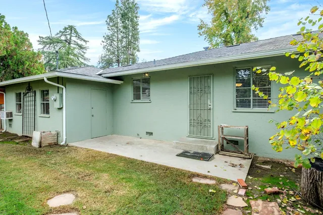 a backyard of a house with table and chairs